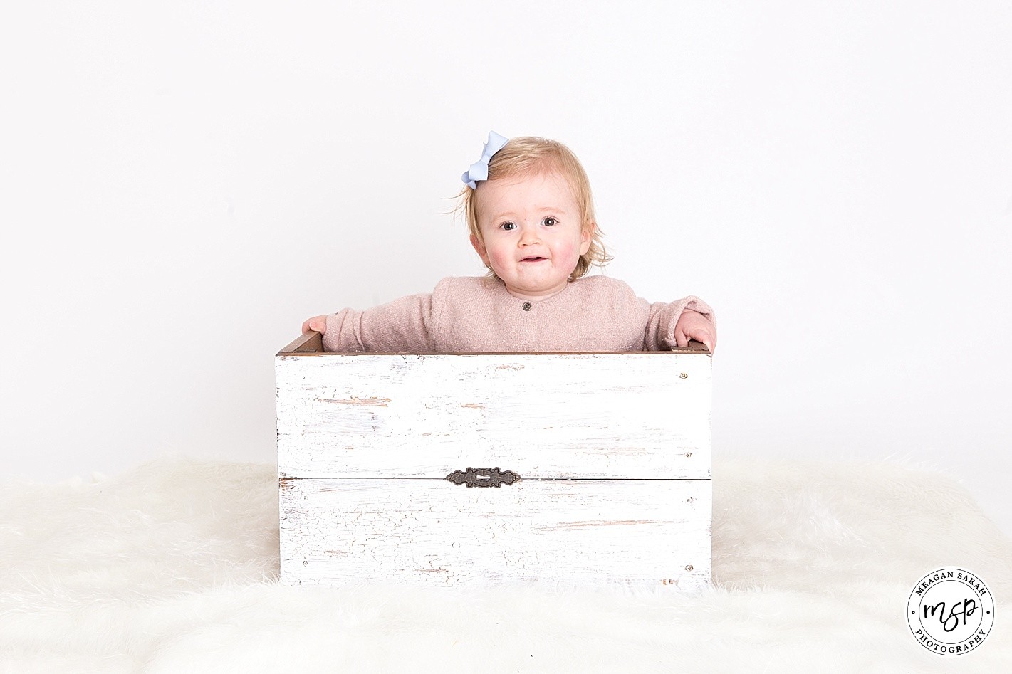 Esme toddler photoshoot by photographer Meagan, white background, In a wooden box, studio, Horsforth