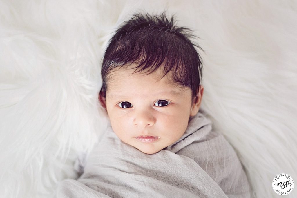 Gorgeous newborn baby with brown eyes