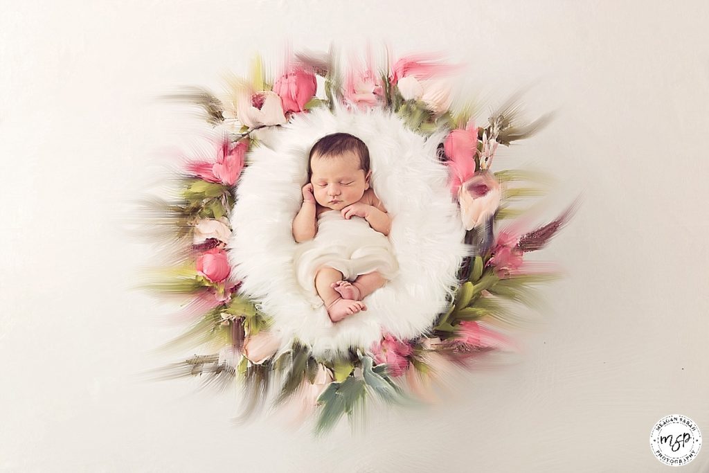 Fine art newborn photography in ring of pink flowers
