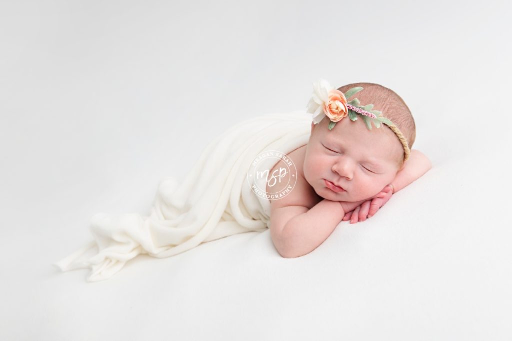 Beautiful newborn photography in Leeds, baby girl on white background, cream, flower headband