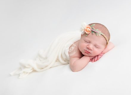Beautiful newborn photography in Leeds, baby girl on white background, cream, flower headband