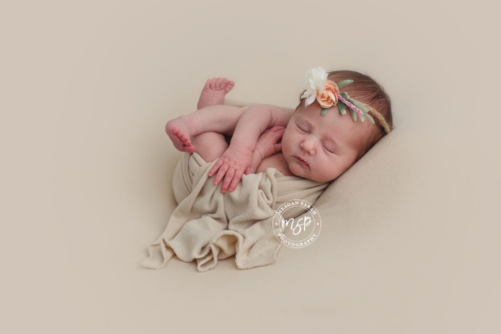 Baby newborn on beige background
