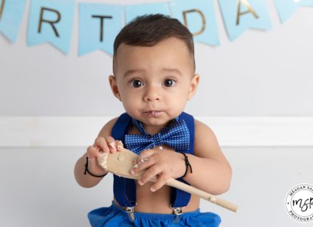 cute boy in blue cake smash with bow tie