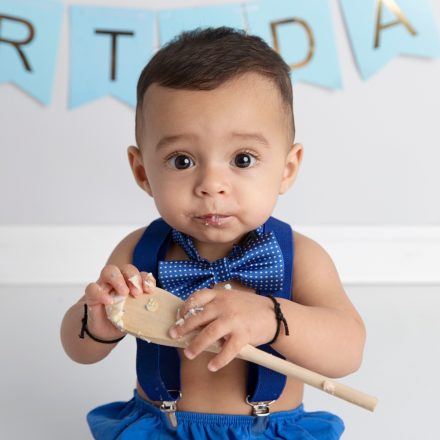 cute boy in blue cake smash with bow tie