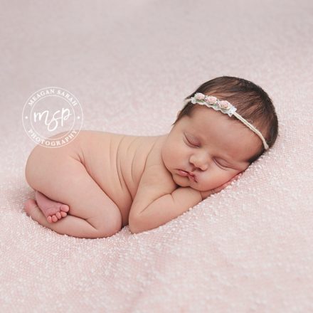 Newborn baby girl photo on pink background in Leeds