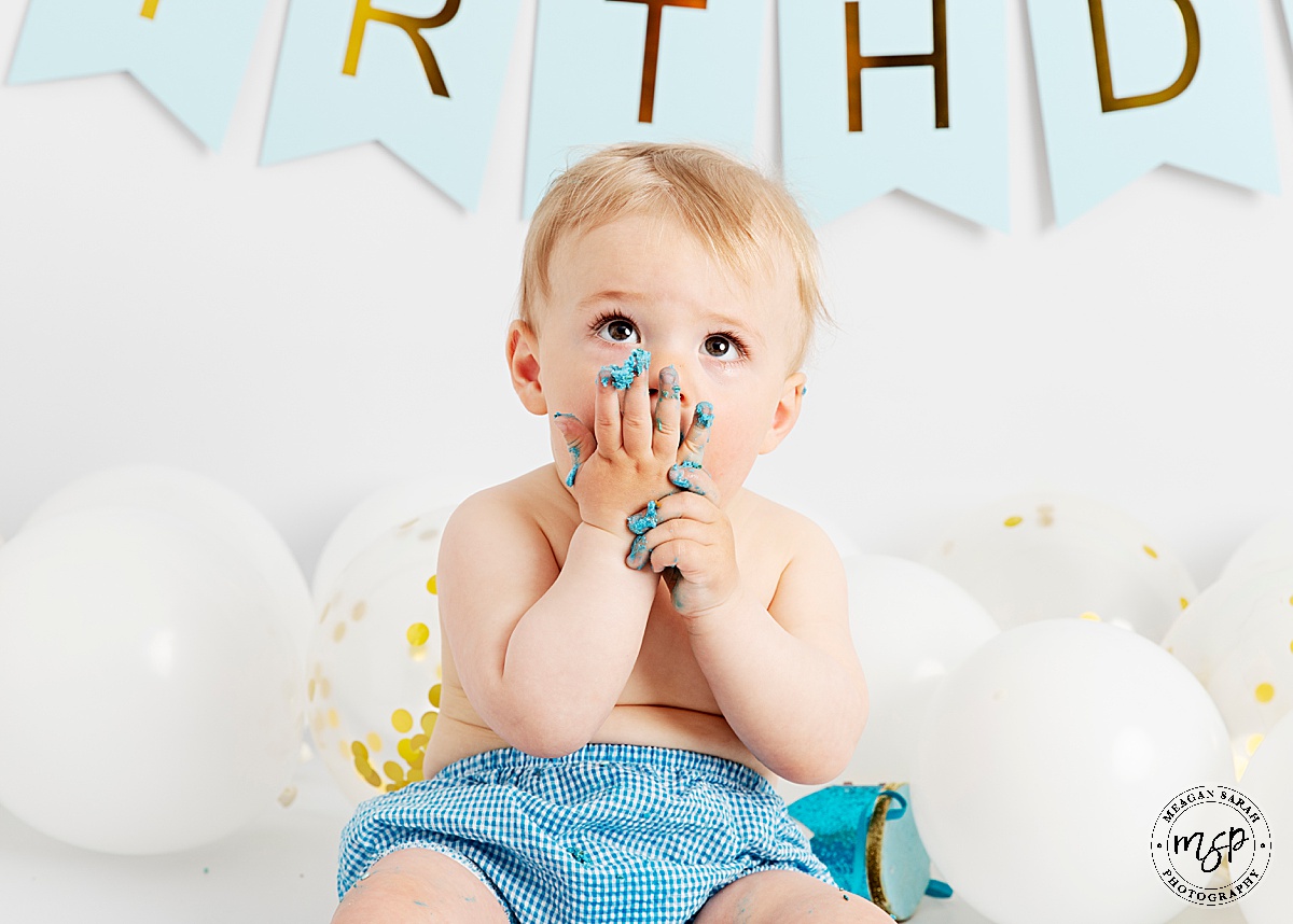 Cake Smash,1st Birthday,Cake,First Birthday,Fun,Funny,Minimal,Modern,Simple,Things to do with a toddler,White background,White balloons,Blue cake,Gold balloon,Children Photographer,High End,High Key,Meagan Sarah Photography,Photographer,Photography,Professional,Studio,Studio photographer,Leeds,Horsforth,West Yorkshire,Happy Birthday,