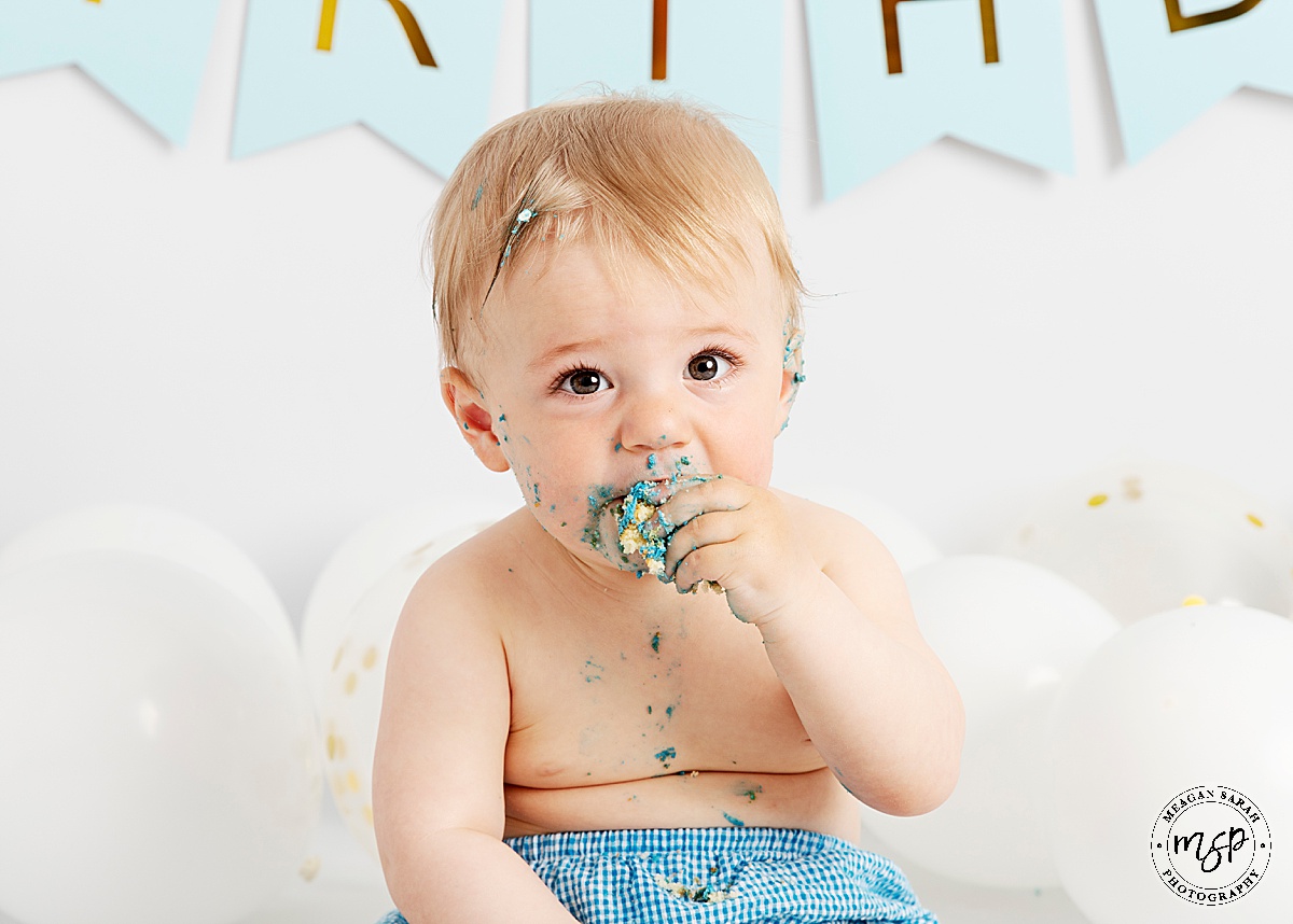 Cake Smash,1st Birthday,Cake,First Birthday,Fun,Funny,Minimal,Modern,Simple,Things to do with a toddler,White background,White balloons,Blue cake,Gold balloon,Studio,Professional,Photography,Photographer,Meagan Sarah Photography,High Key,High End,Children Photographer,Studio photographer,Leeds,Horsforth,West Yorkshire,Happy Birthday,