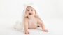 Cute little boy on fur rug, white dressing gown, sitter session, photography