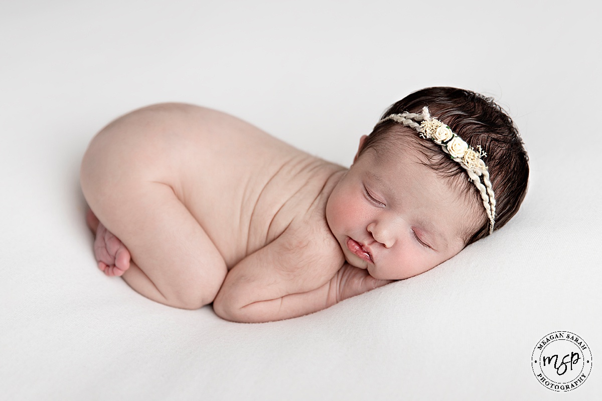 Girl,Meagan Sarah Photography,small baby,Newborn baby,Horsforth,Leeds,West Yorkshire,Studio,Beautiful Photography,Children Photographer,High End,High Key,Photographer,Photography,Professional,Studio photographer,White backdrop,SirtsuHandmade,Floral headband,Bum up,Laying on belly,Asleep,Close up,Russian doll,