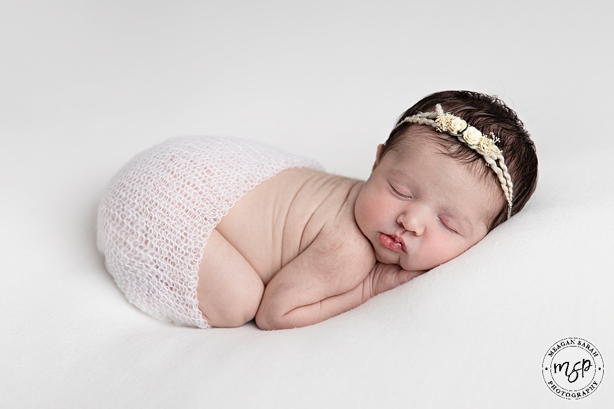 Girl,Meagan Sarah Photography,small baby,Newborn baby,Horsforth,Leeds,West Yorkshire,Studio,Beautiful Photography,Children Photographer,High End,High Key,Photographer,Photography,Professional,Studio photographer,White backdrop,SirtsuHandmade,Floral headband,Bum up,Laying on belly,Asleep,Close up,Russian doll,