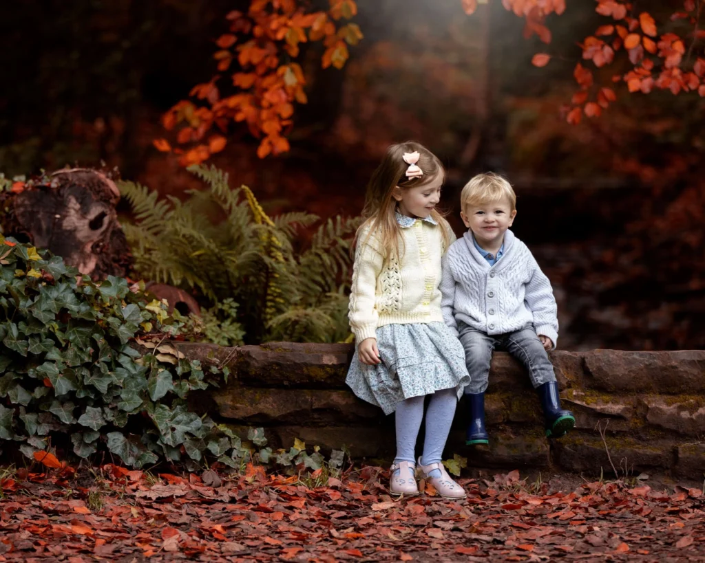 magical photo of two children sitting on a wall at Roundhay Park, Leeds for their professional photoshoot.