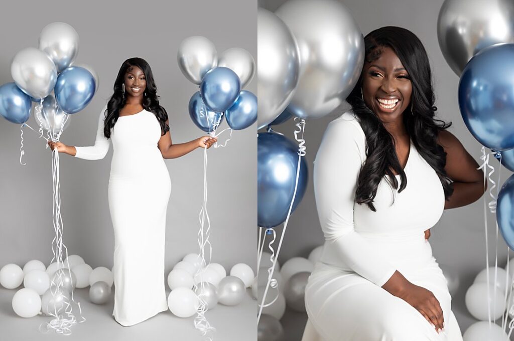 A grown up studio birthday shoot portrait. With blue and silver balloons against a grey background. Birthday shoot. Fun, happy, relaxed.