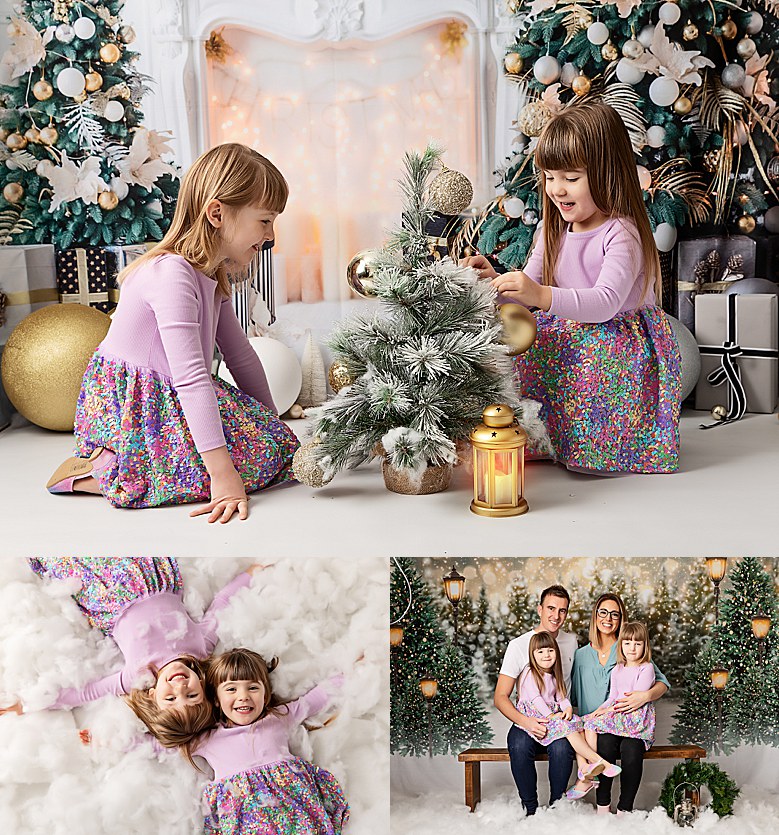 Christmas family photoshoot. Photo against a faux christmas scene of a homely fireplace, gifts and tree. Two sisters sitting playing and posing for the camera. Colour theme is lilac and greens.