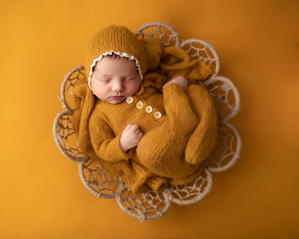 Baby photography Leeds. Baby photographer. Baby asleep in basket. All in yellow. Newborn baby photographer Leeds.