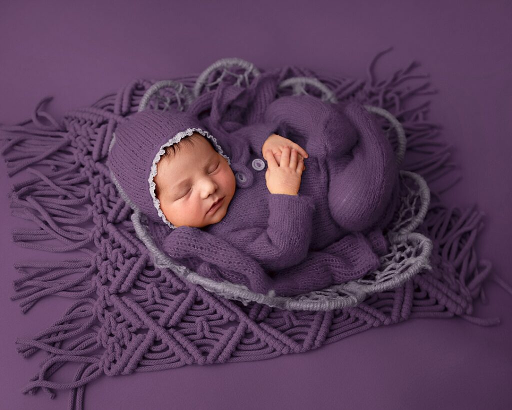 Newborn photography Leeds. Baby photographer. Purple set with purple backdrop.