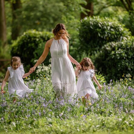 Beautiful image of a mother and her two daughters all in white running through long grass. Photograph taken and Kirkstall Abbey Leeds. Part of our Mummy and Me photoshoot sessions. mini session. outdoor photography.